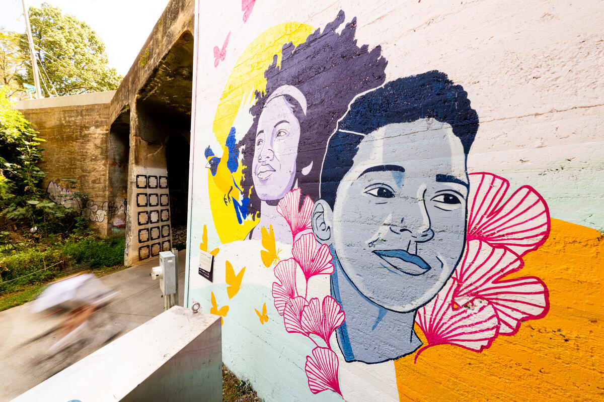 Attendees interacting with the new mural in Atlanta.