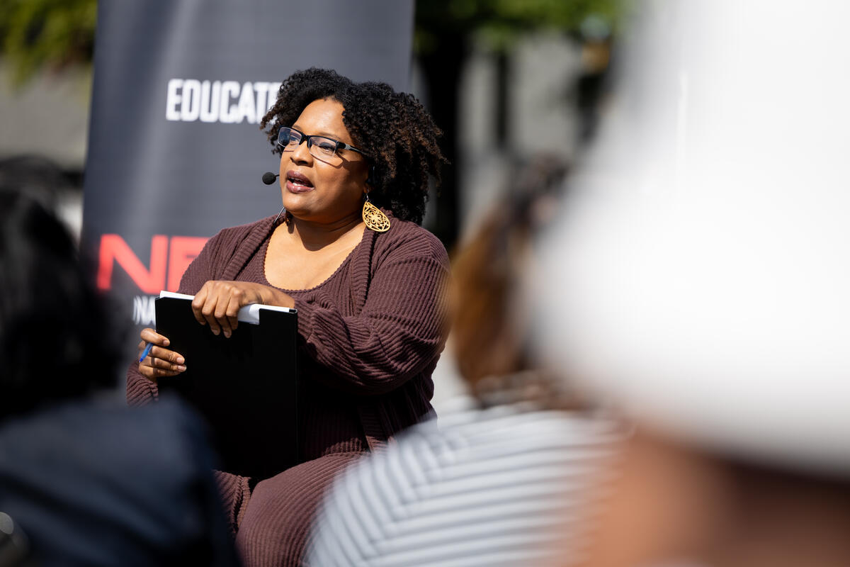 Speaker at the podium during the Atlanta mural event.